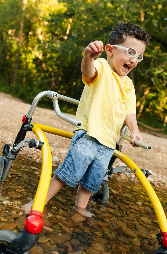 Child playing on a playground structure with a natural background